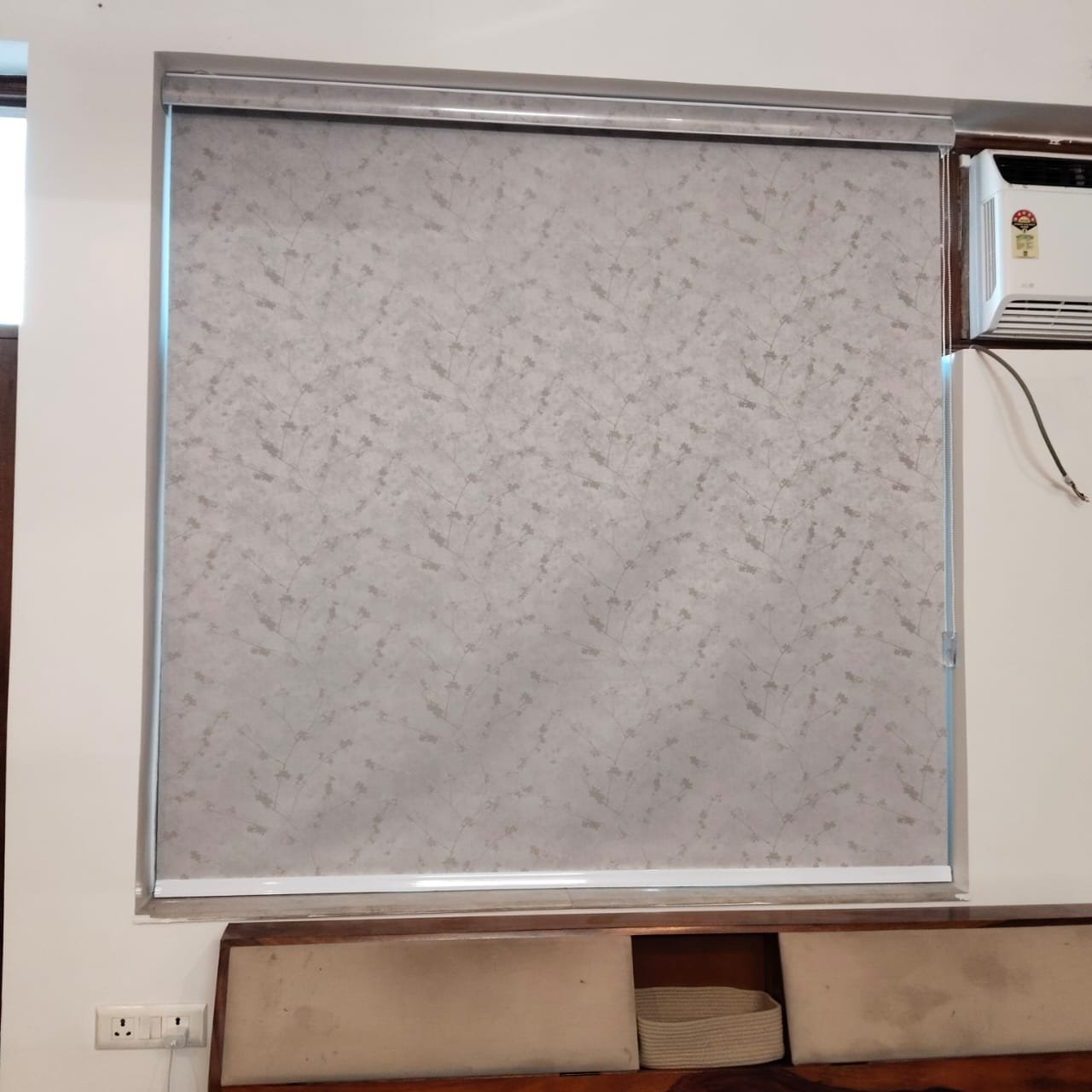 Premium textured fabric blackout roller blind installed on bedroom window in Greater Noida