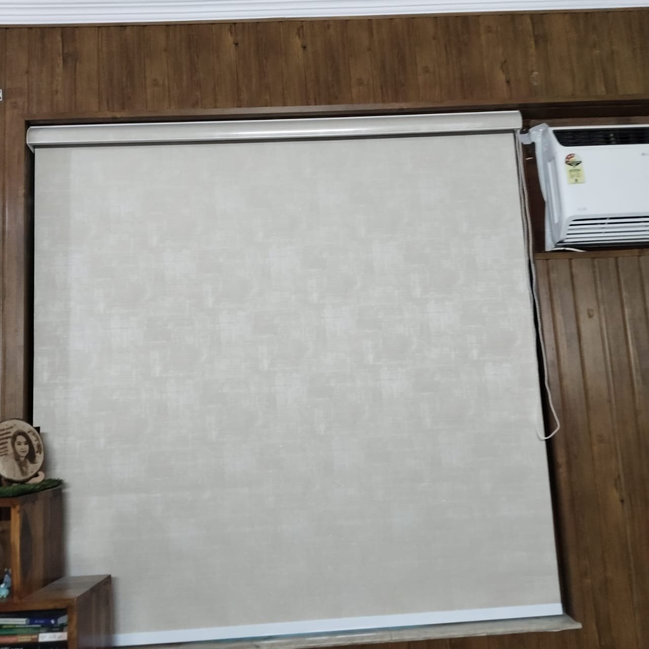Sleek sunscreen roller blind providing total glare control and privacy for residential room