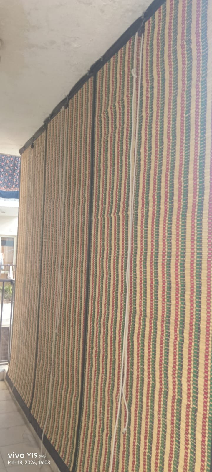 Green, red and natural bamboo striped artisan chick blind for balcony decor